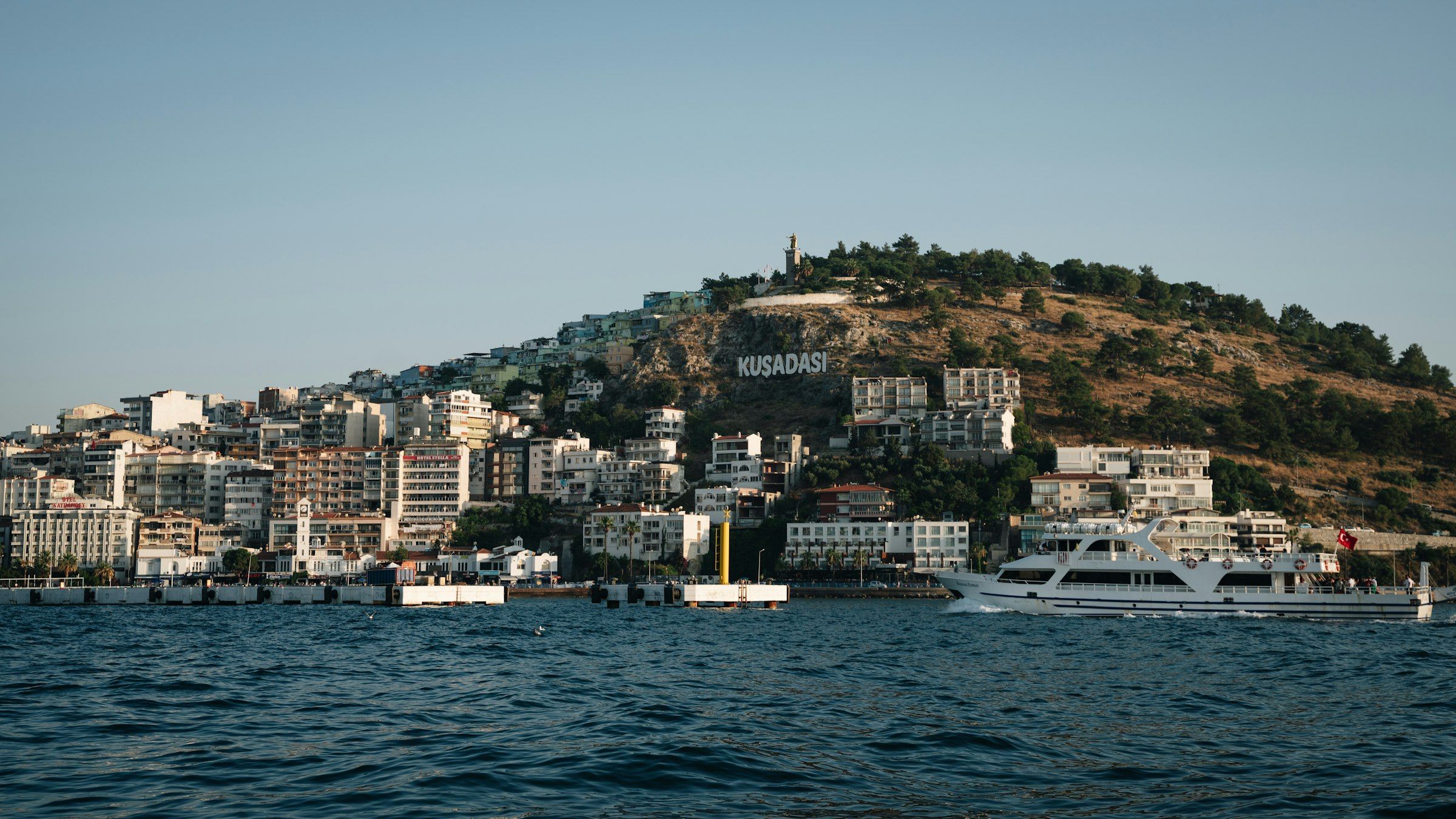 A boat on the water in front of Kuşadası